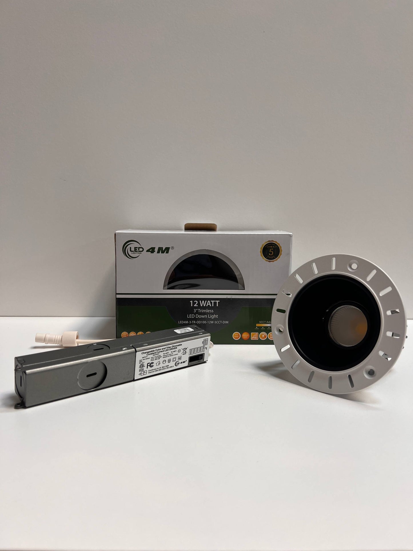 LED light bulb, driver, and packaging on a white surface with a gray background | Selix Kala