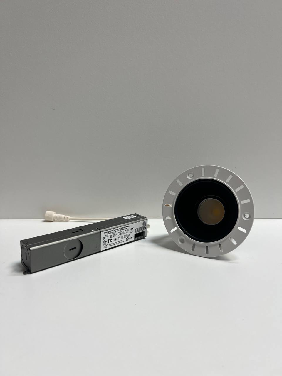 Light fixture and packaging on a white surface with gray background | Selix Kala